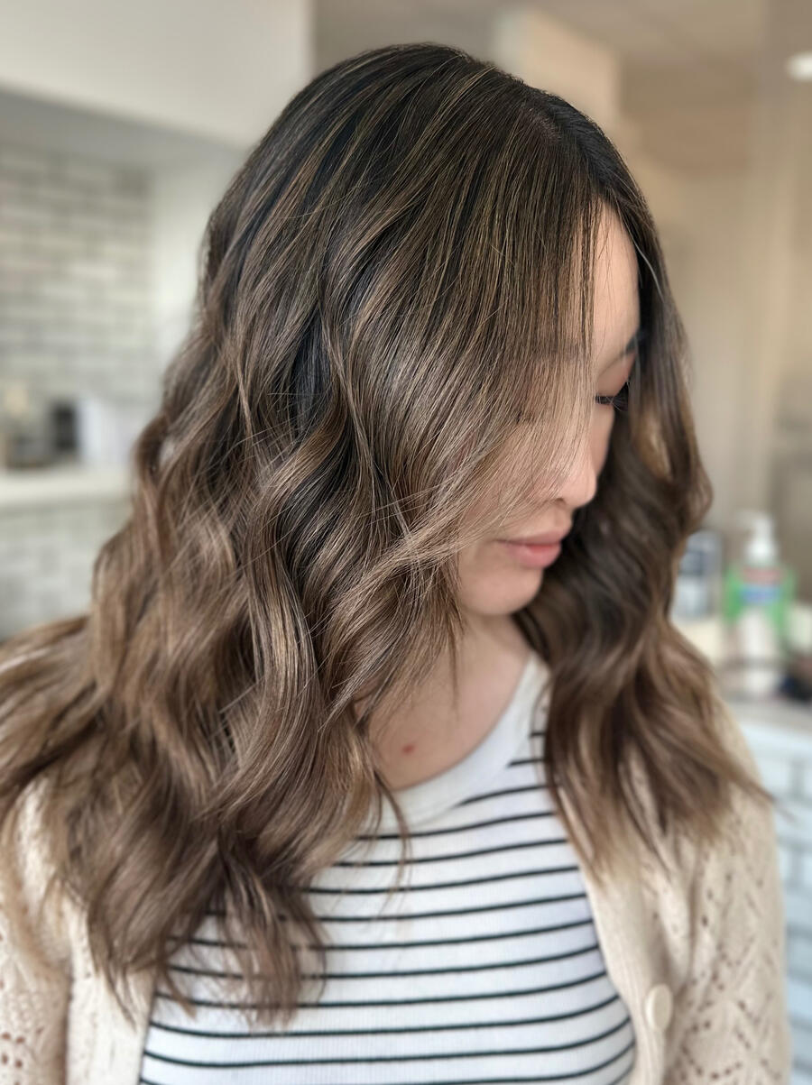 Asian custom blonding A photo of a dark blonde client showcasing her hair.